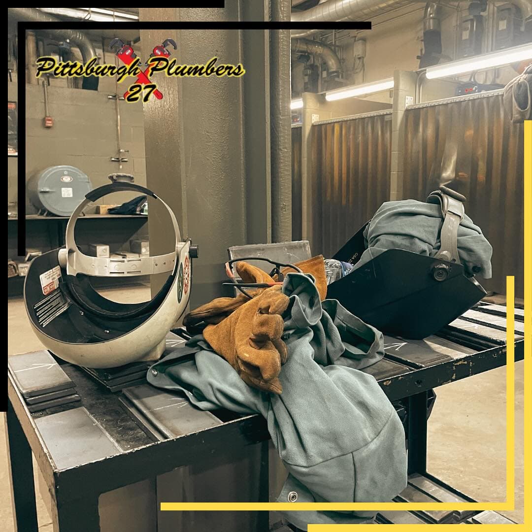 Welding hoods and leathers staged at the UA Local 27 welding shop.